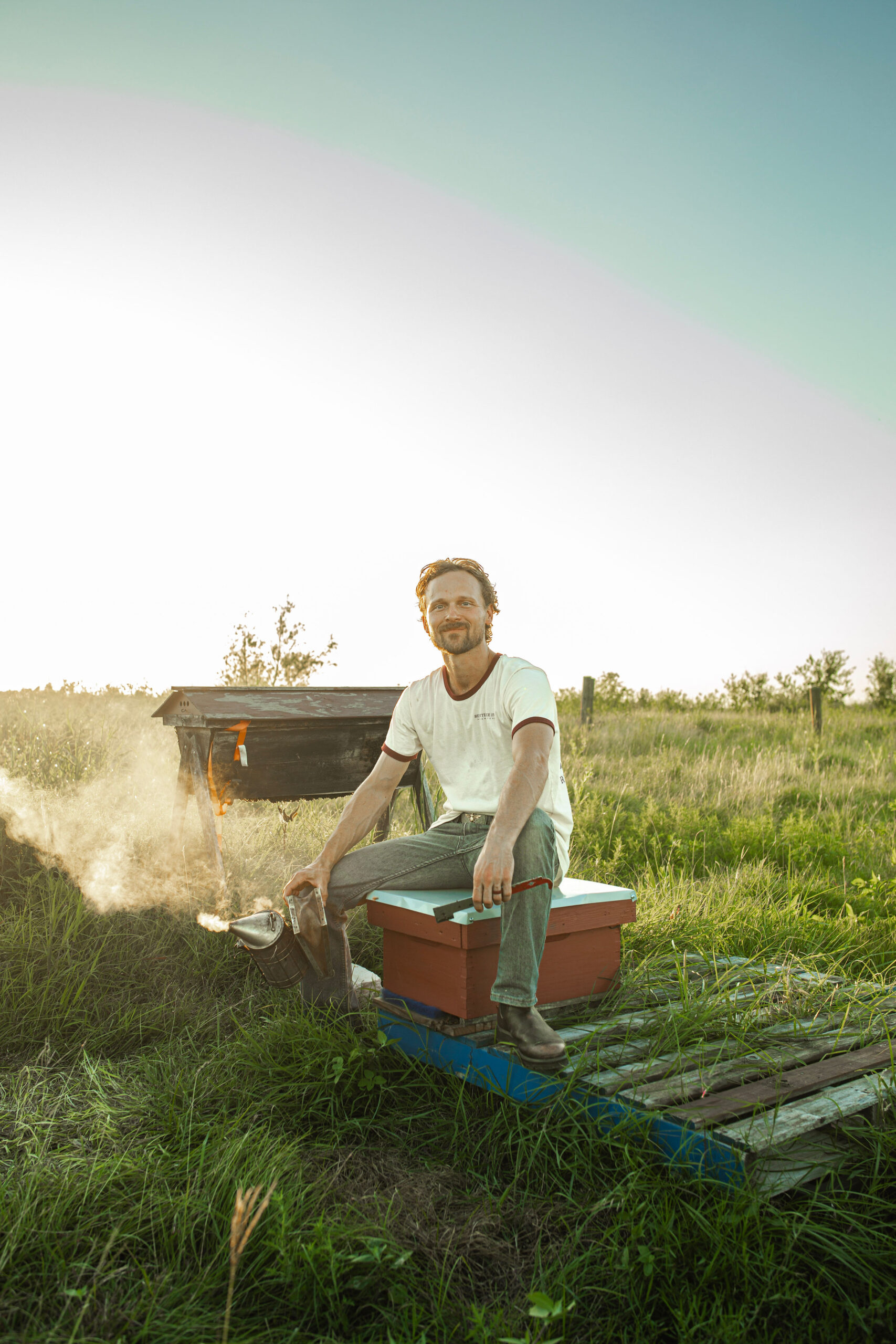 beekeeper on beehive in central tx